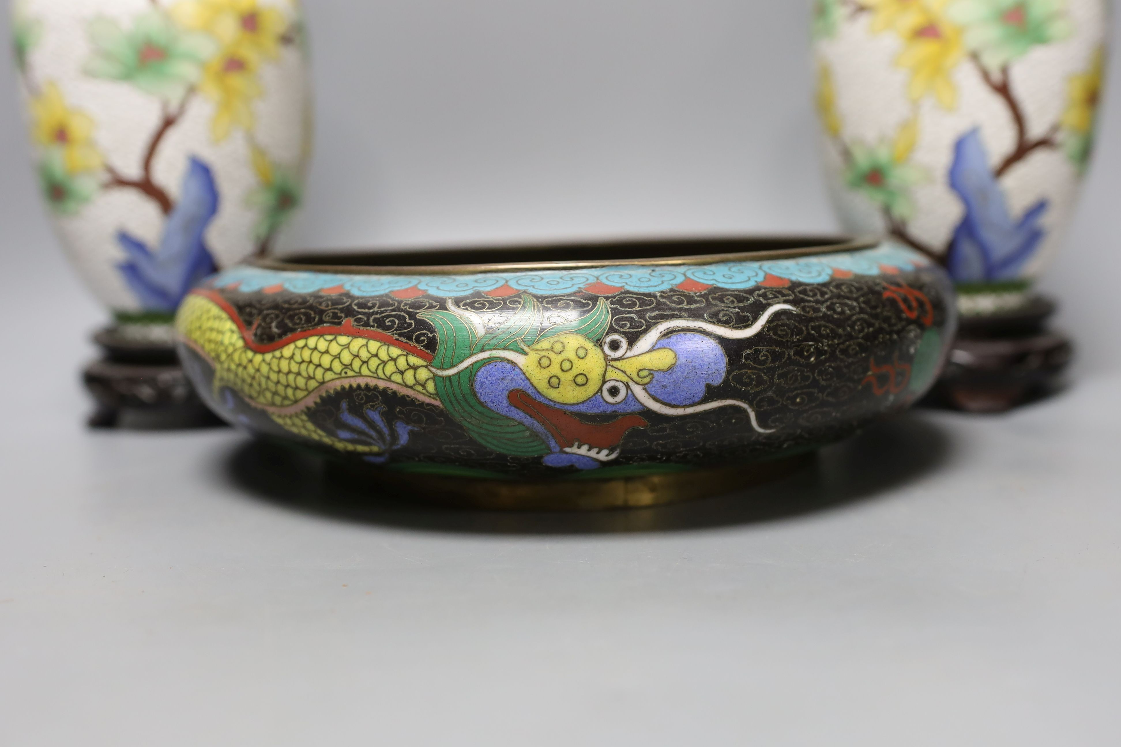 A pair of Chinese cloisonné enamel vases, 25cm tall including stands, together with a Chinese cloisonné enamel dragon bowl (3)